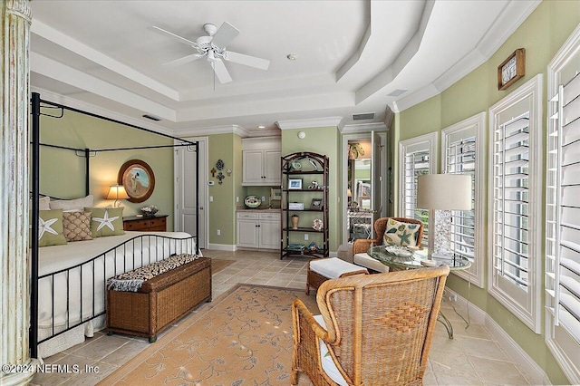 sitting room with crown molding, ceiling fan, and a tray ceiling