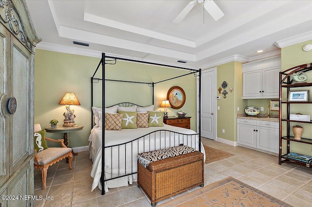 bedroom featuring ceiling fan, ornamental molding, and a raised ceiling