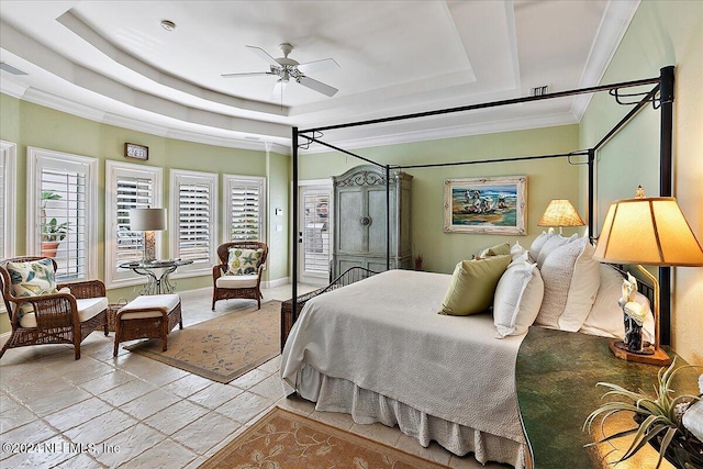 bedroom with crown molding and a raised ceiling