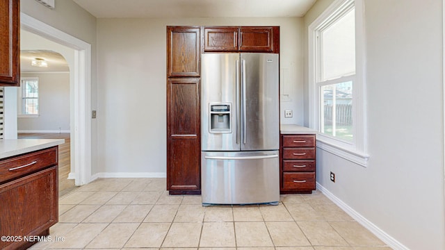 kitchen featuring light tile patterned floors and stainless steel fridge