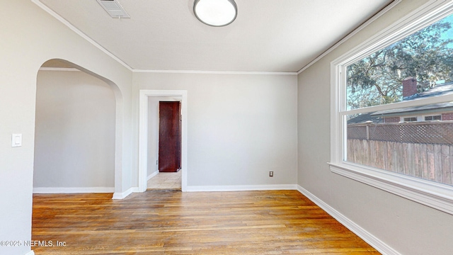 unfurnished room featuring wood-type flooring and ornamental molding