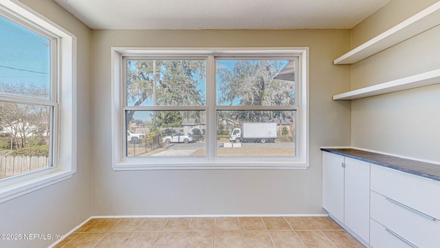 unfurnished dining area featuring light tile patterned floors