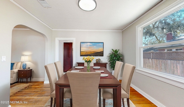 dining room featuring crown molding and hardwood / wood-style floors