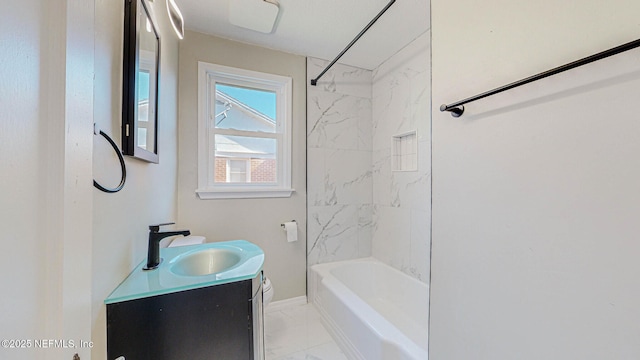 bathroom featuring tiled shower / bath and vanity