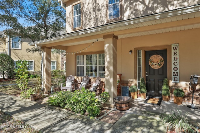 view of exterior entry with covered porch