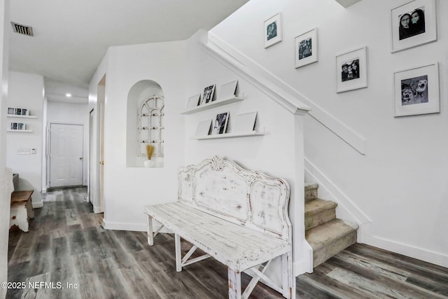 stairs featuring wood-type flooring