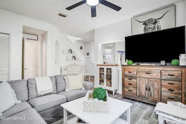 living room with wood-type flooring and ceiling fan