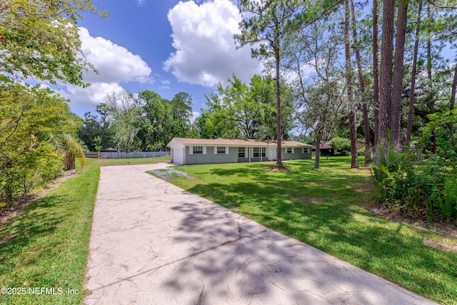 view of front of home with an outbuilding and a front yard