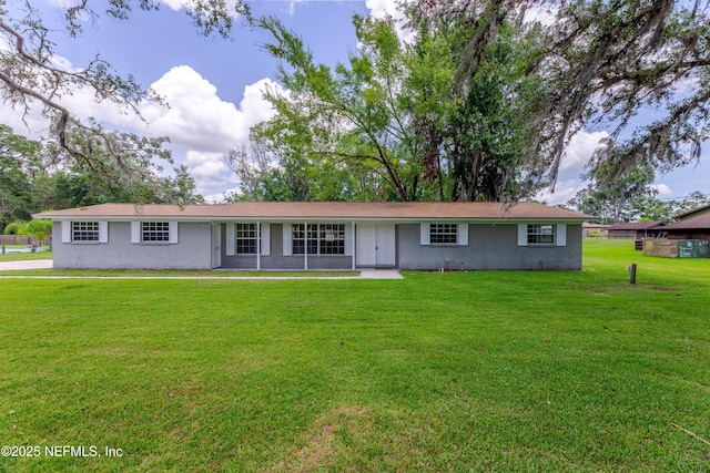 ranch-style home with a front lawn