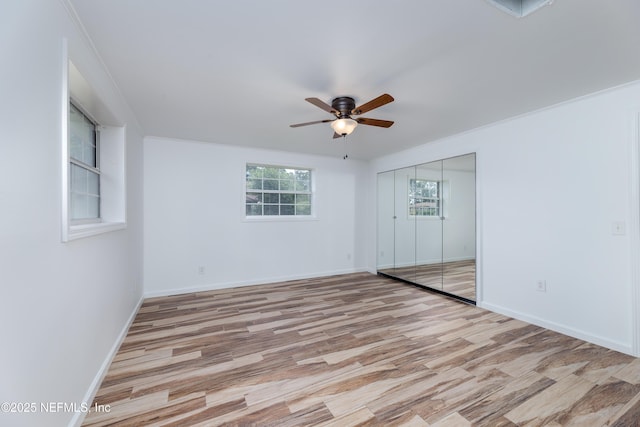 spare room featuring light hardwood / wood-style floors and ceiling fan