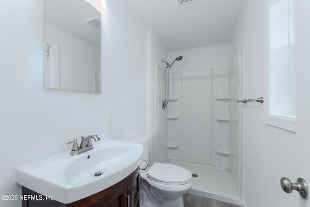 bathroom with vanity, walk in shower, crown molding, and toilet