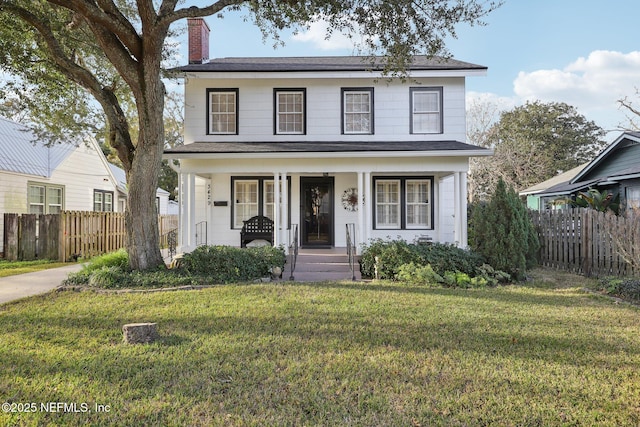 view of front of home featuring covered porch and a front lawn