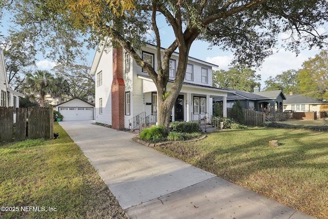 view of front of house featuring a garage, an outdoor structure, and a front lawn