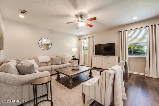 living room featuring plenty of natural light, hardwood / wood-style floors, a textured ceiling, and ceiling fan