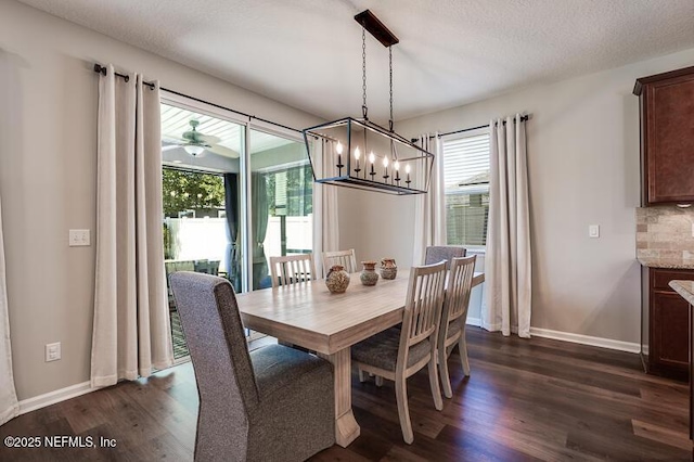 dining space featuring a textured ceiling and dark hardwood / wood-style flooring