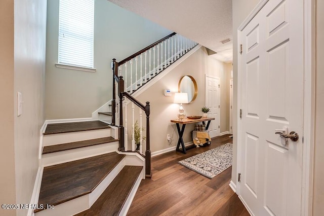 staircase with hardwood / wood-style floors