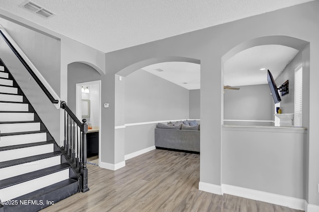 interior space featuring a textured ceiling and light wood-type flooring