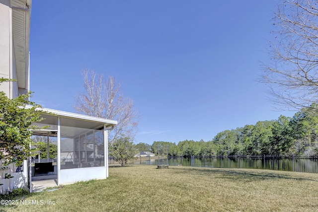 view of yard with a water view and a sunroom