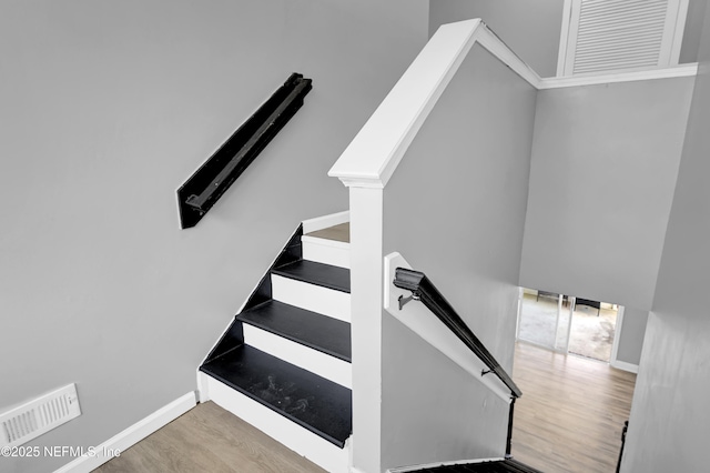 stairway with hardwood / wood-style flooring