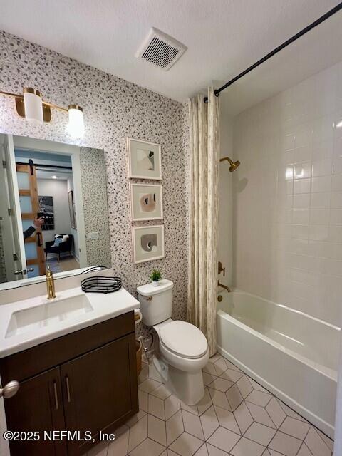 full bathroom featuring tile patterned flooring, toilet, vanity, and shower / bath combo with shower curtain