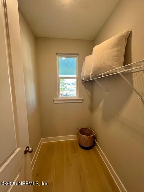 spacious closet featuring hardwood / wood-style flooring