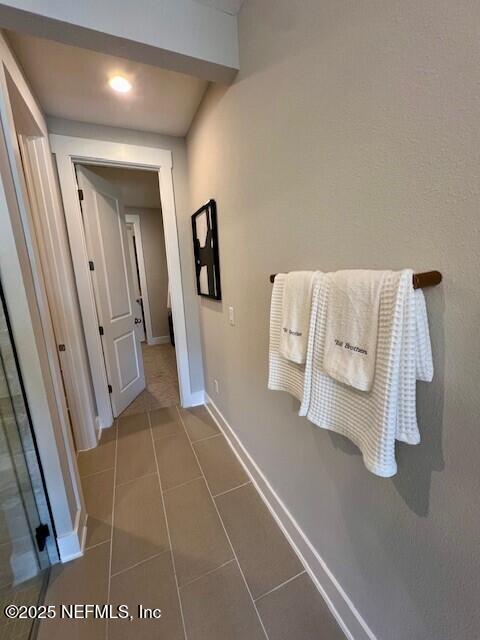 hall featuring tile patterned flooring