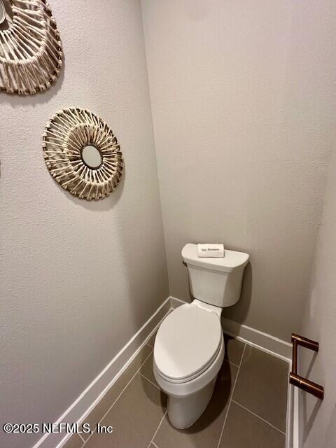 bathroom with tile patterned floors and toilet