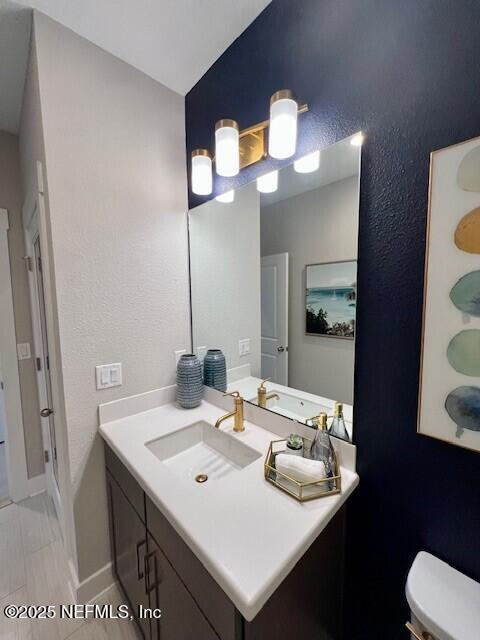 bathroom with vanity and toilet