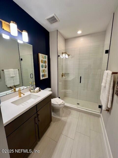 bathroom with vanity, toilet, and walk in shower