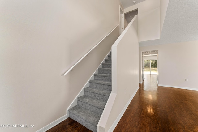 staircase featuring hardwood / wood-style floors