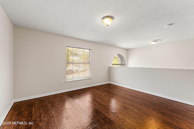 spare room with hardwood / wood-style flooring and a textured ceiling