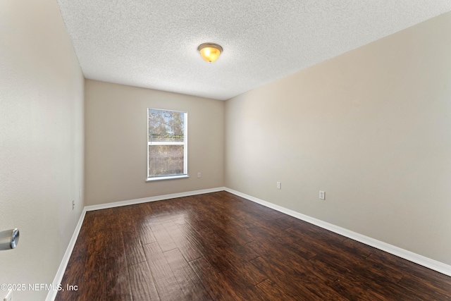 unfurnished room featuring hardwood / wood-style flooring and a textured ceiling