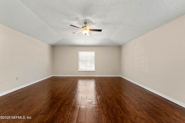 empty room with dark hardwood / wood-style floors, a textured ceiling, and ceiling fan