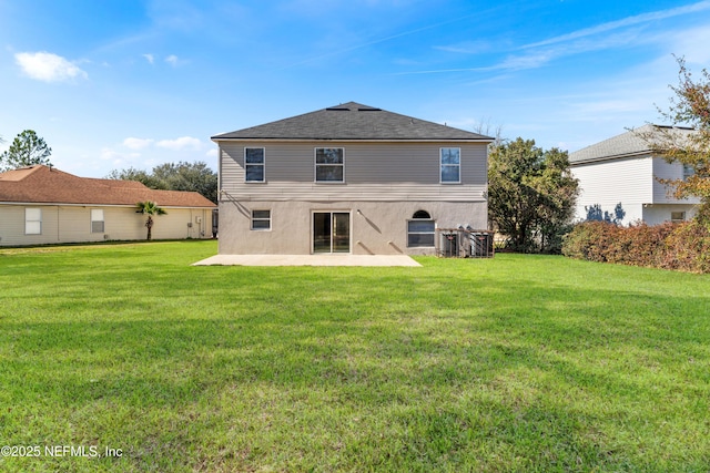 back of property with a lawn and a patio area