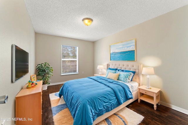 bedroom with dark hardwood / wood-style floors and a textured ceiling