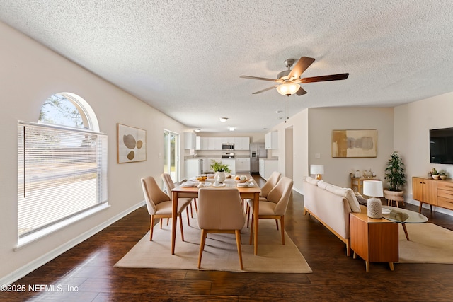 dining area featuring ceiling fan, a textured ceiling, dark hardwood / wood-style floors, and a healthy amount of sunlight