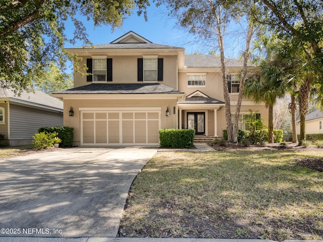 view of front of property featuring a garage and a front yard