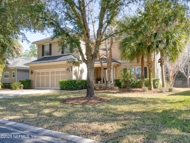 view of front of house featuring a garage and a front lawn