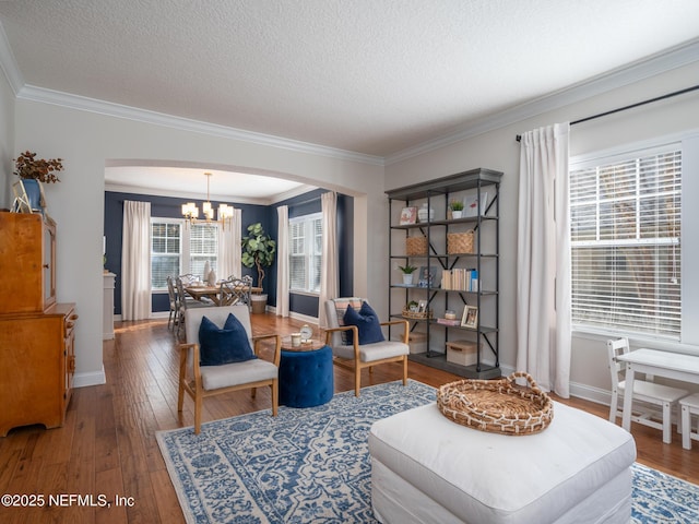 sitting room featuring an inviting chandelier, hardwood / wood-style flooring, and a textured ceiling