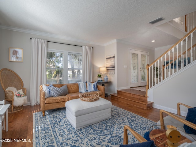 living room with crown molding, hardwood / wood-style floors, and a textured ceiling