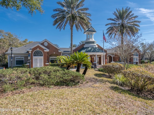 view of front facade featuring a front lawn and french doors