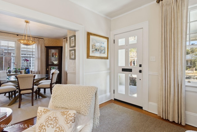 interior space featuring hardwood / wood-style floors and crown molding