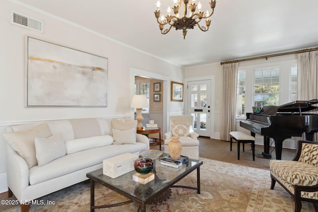 living room with ornamental molding, carpet flooring, and a notable chandelier