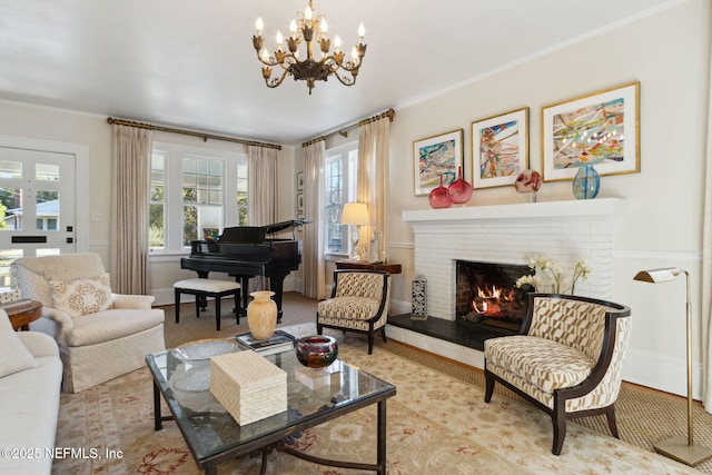 living area with a notable chandelier, crown molding, and a fireplace