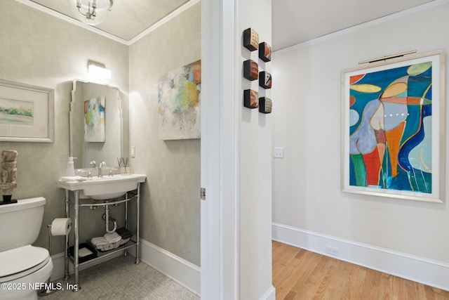 bathroom with sink, ornamental molding, hardwood / wood-style floors, and toilet