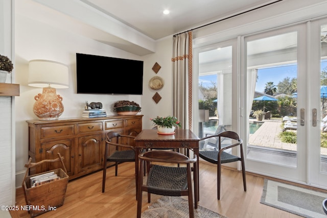 dining room featuring ornamental molding and light hardwood / wood-style floors