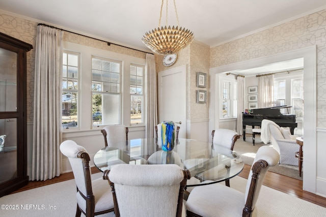 dining room with a wealth of natural light, ornamental molding, and wood-type flooring