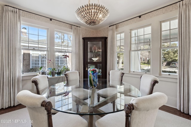 dining area featuring hardwood / wood-style floors and a notable chandelier