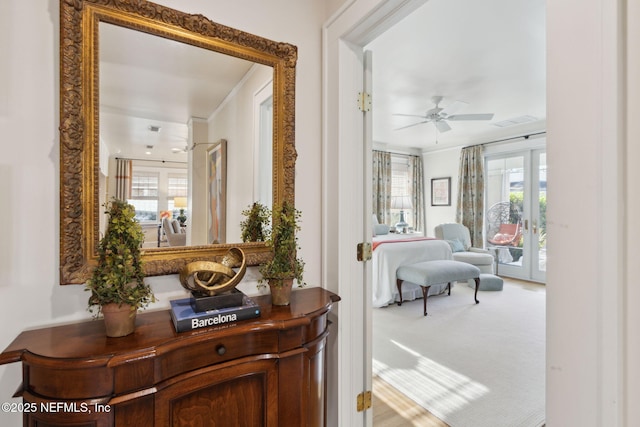 corridor with french doors, carpet, and a wealth of natural light