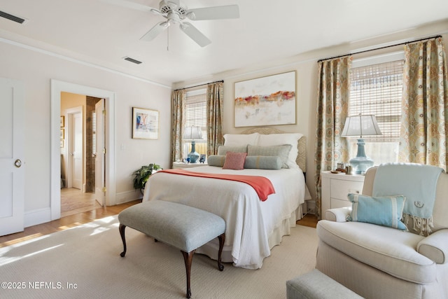 bedroom with ceiling fan, ornamental molding, and light hardwood / wood-style flooring